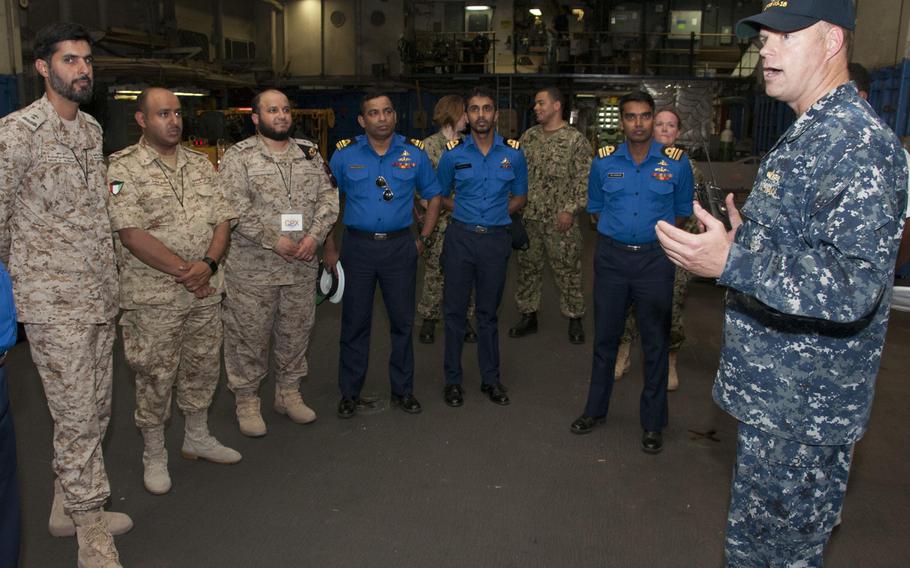 Lt. Mick Kalman discusses the capabilities of Afloat Forward Staging Base (Interim) USS Ponce with participants of the International Maritime Exercise (IMX) 2017. 