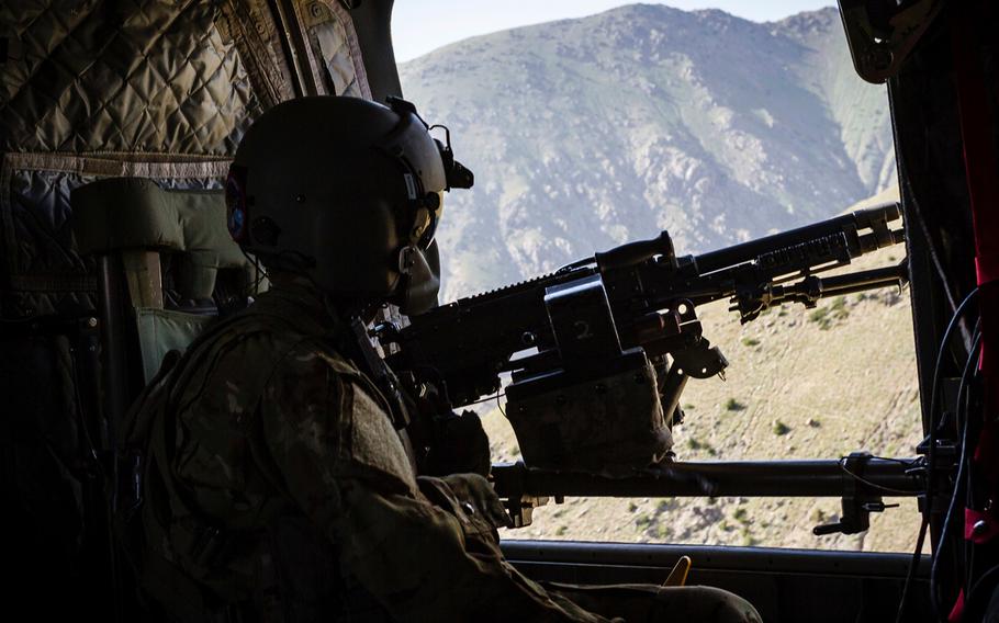 A U.S. Army CH-47 Chinook helicopter crew chief scans below near Mazar-e-Sharif, Afghanistan, on June 9, 2017. An Afghan official confirmed Saturday, June 17, that an insider attack took place at a camp in Mazar-e Sharif.