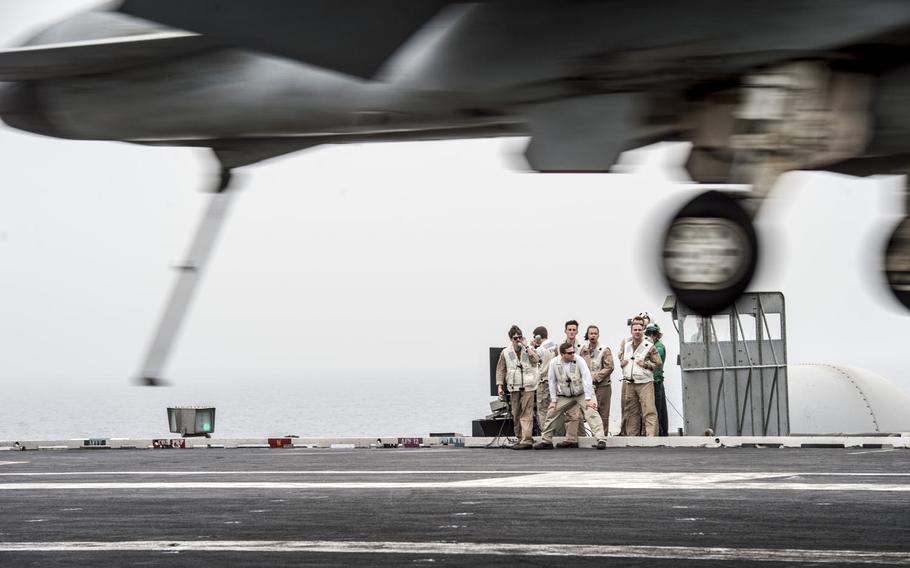 Landing officers grade the landing of an aircraft onboard the aircraft carrier USS George H.W. Bush in the Persian Gulf on April 19, 2017.