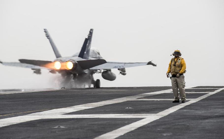 An F/A-18C Hornet launches from the flight deck of aircraft carrier USS George H.W. Bush in the Persian Gulf.