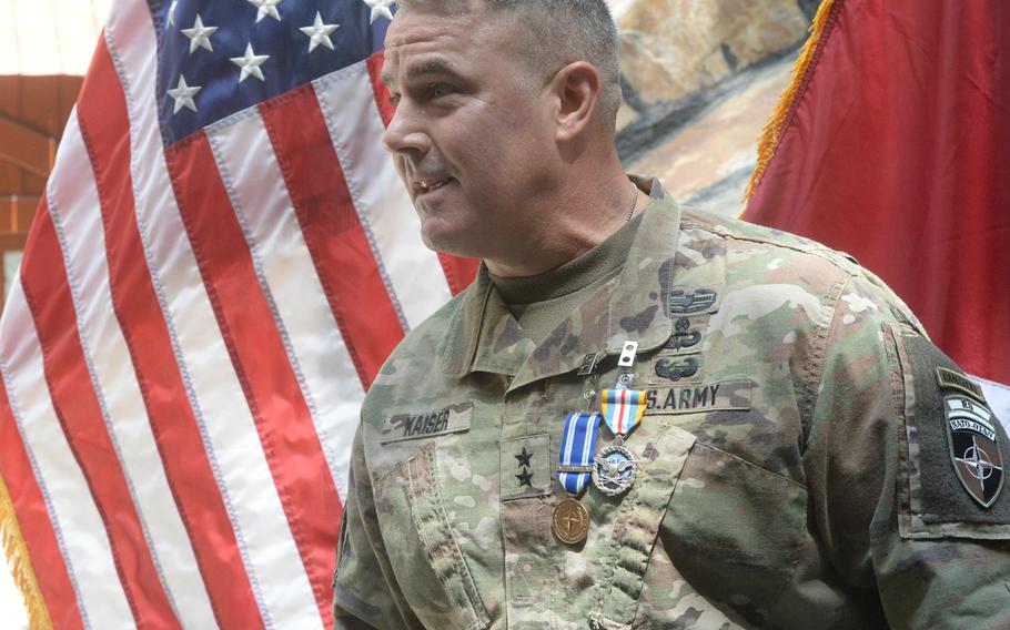 Army Maj. Gen. Richard G. Kaiser, outgoing commander of Combined Security Transition Command-Afghanistan, speaks with colleagues after being awarded two medals on Saturday, July 15, 2017.