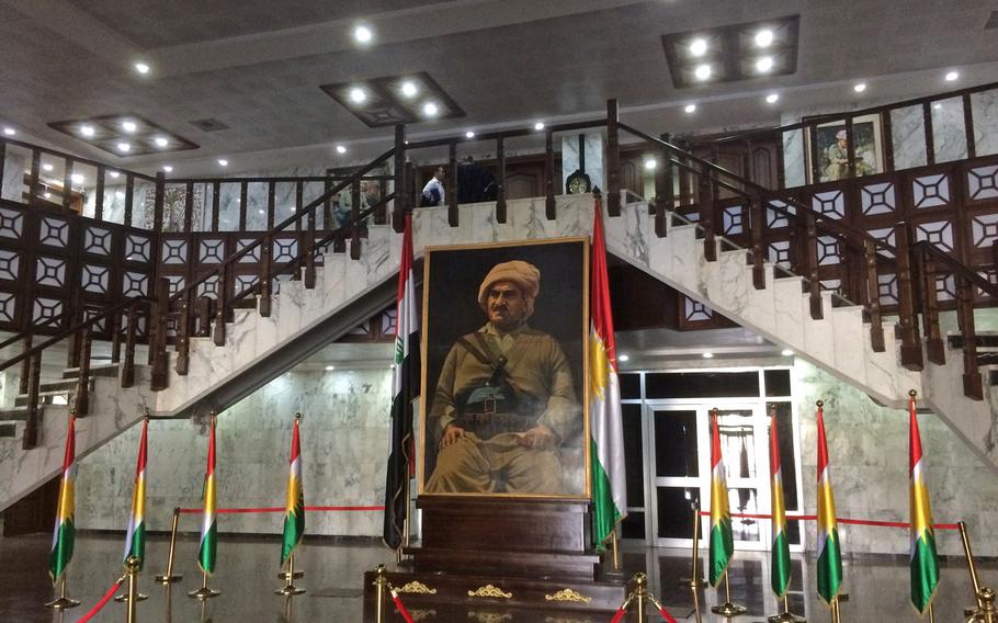 Portraits of peshmerga heroes hang on the walls of a large, multi-story building that houses the Kurdistan parliament. 
