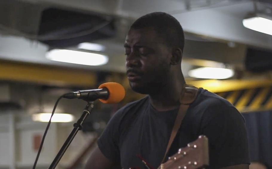 A video screen grab shows Seaman Maxwell "Emay" Holmes performing "Cell Block 68" while deployed on the USS Nimitz in the Persian Gulf in August 2017.