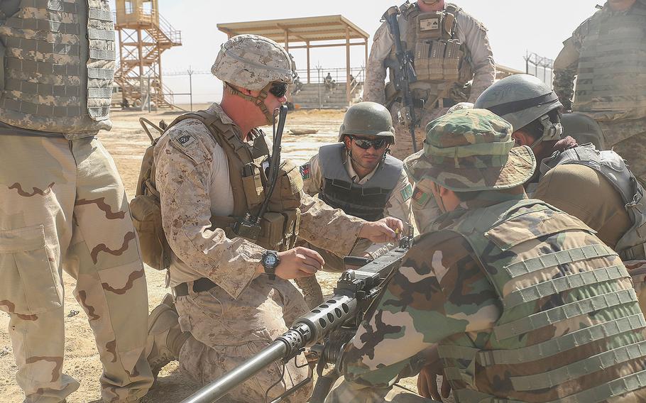 A Marine advisor with Task Force Southwest demonstrates proper firing techniques on a M2 Browning .50 Machine Gun to Afghan National Army soldiers with the Helmand Regional Military Training Center during a live-fire range at Camp Shorabak, Afghanistan, Aug. 17, 2017.