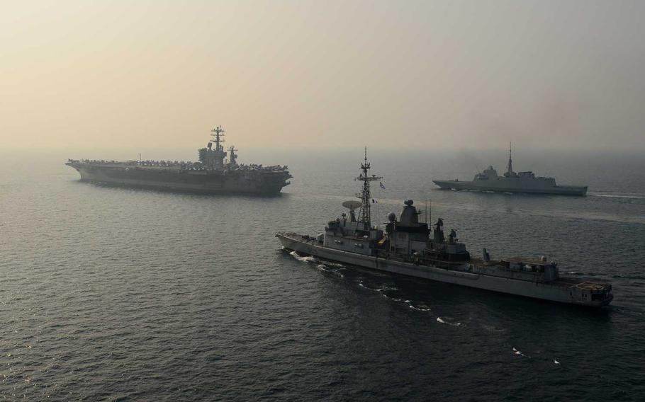 The aircraft carrier USS Nimitz (CVN 68), middle, conducts a formation group sail with the French navy air defense destroyer FS Jean Bart (D615), top, and the French navy destroyer FS Auvergne (D654) in the Arabian Gulf. On Saturday, the French military announced its first combat death in the anti-Islamic State fight.
