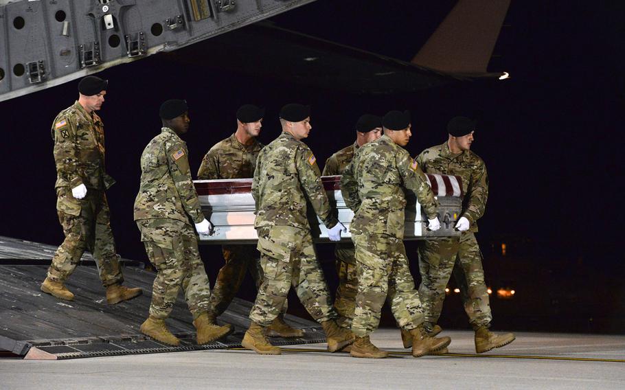 A U.S. military carry team transfers the remains of Army Staff Sgt. Dustin Wright late Thursday, Oct. 5, 2017, upon arrival at Dover Air Force Base, Del. Wright was one of four U.S. troops killed in an ambush by dozens of Islamic militants. Wright along with Staff Sgts. Jeremiah W. Johnson, and Bryan C. Black were identified Friday, Oct. 6, as three of the four killed. The military on Saturday, Oct. 7, identified Sgt. La David Johnson as the fourth soldier killed.