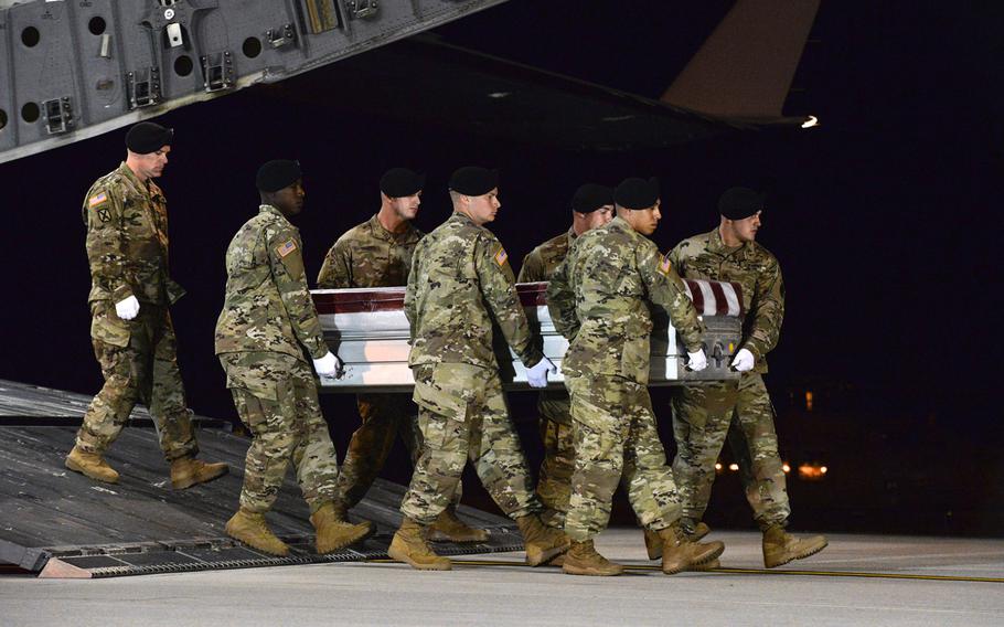 A U.S. military carry team transfers the remains of Army Staff Sgt. Dustin Wright late Thursday, Oct. 5, 2017, upon arrival at Dover Air Force Base, Del.  Wright was one of four U.S. troops killed in an ambush by dozens of Islamic militants. Wright along with Staff Sgts. Jeremiah W. Johnson, and Bryan C. Black were identified Friday, Oct. 6, as three of the four killed. The military on Saturday, Oct. 7, identified Sgt. La David Johnson as the fourth soldier killed. 