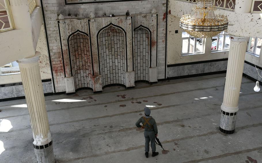 An Afghan security official inspects the Imam Zaman mosque in Kabul, Afghanistan, on Saturday, Oct. 21, 2017, a day after an Islamic State suicide bomber attack. 