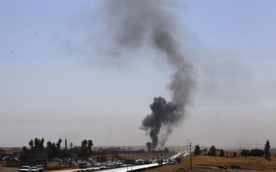 Smoke rises as Iraqi security forces launch explosives as Kurdish security forces withdraw from a checkpoint in Altun Kupri, on the outskirts of Irbil, Iraq, Friday Oct. 20, 2017. 