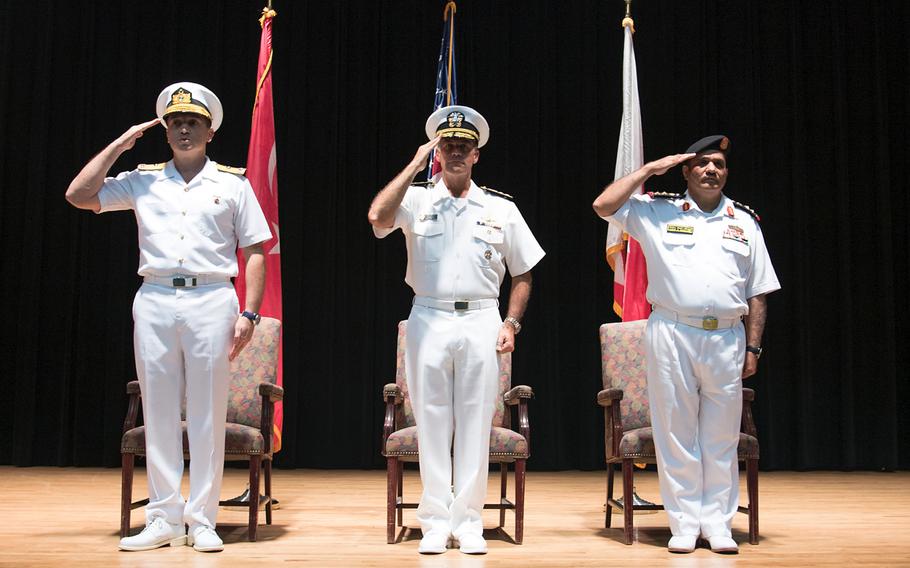 U.S. Navy Vice Adm. John Aquilino, commander of the Combined Maritime Forces, center, presides while Turkish Naval Forces Rear Adm. Emre Sezenler, left, turns over command of Combined Task Force 151 to Royal Bahrain Navy Capt. Yusuf Almannaei, right, at Naval Support Activity Bahrain, Nov. 2, 2017. 

