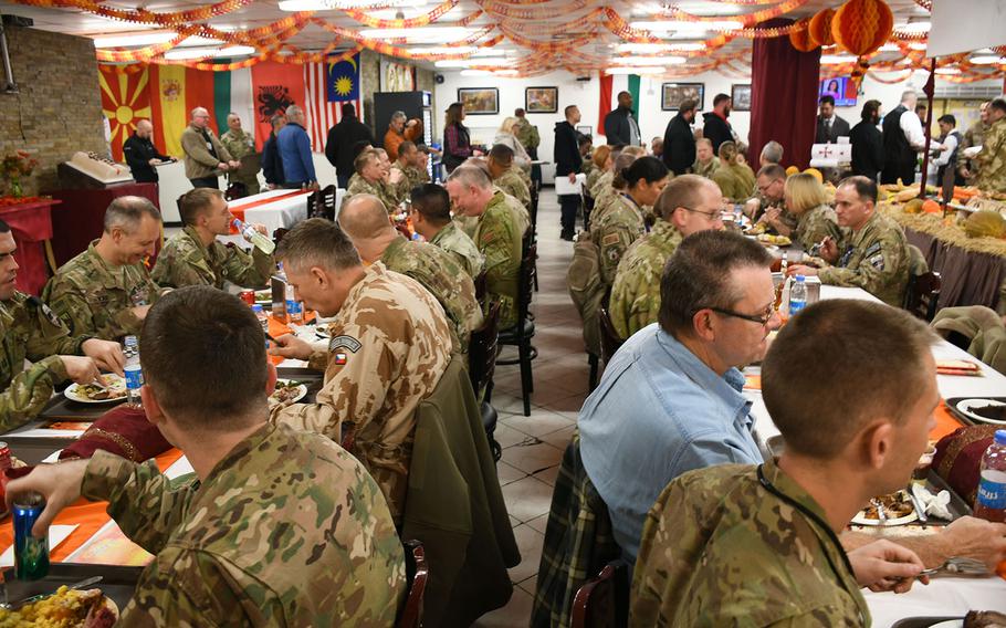 Troops and contractors eat Thanksgiving dinner at NATO's Resolute Support headquarters in Kabul, Afghanistan, on Thursday, Nov. 23, 2017. 

