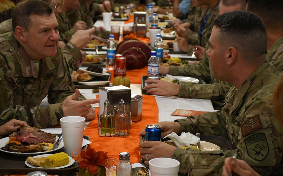 Vice Adm. Luke McCollum, chief of Navy Reserve and commander of the Navy Reserve Force, left, and Navy Rear Adm. Phillip Lee Jr. serve Thanksgiving dinner to troops and contractors at NATO's Resolute Support headquarters in Kabul on Thursday, Nov. 23, 2017.

