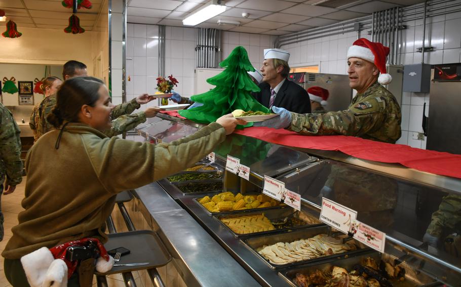 Maj. Gen. Leon N. Thurgood, deputy commander of the Combined Security Transition Command - Afghanistan, serves up Christmas Day dinner at a dining facility on Resolute Support headquarters in Kabul, Afghanistan on Monday, Dec. 25, 2017.