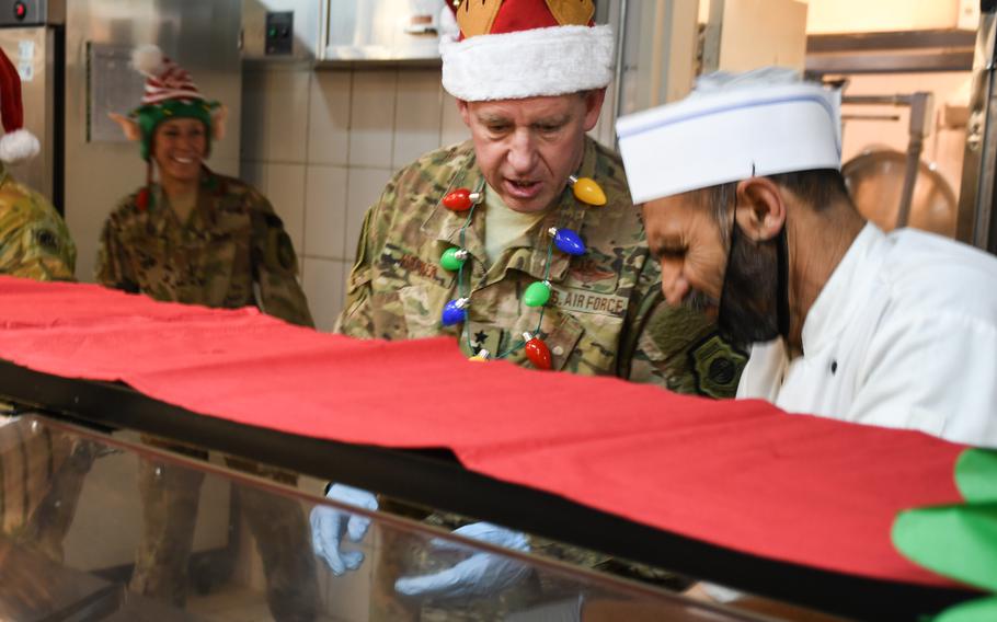 Maj. Gen. James B. Hecker, commander of the 9th Air and Space Expeditionary Task Force - Afghanistan, prepares to end his shift serving Christmas Day dinner for troops at a dining facility on Resolute Support headquarters in Kabul, Afghanistan on Monday, Dec. 25, 2017.