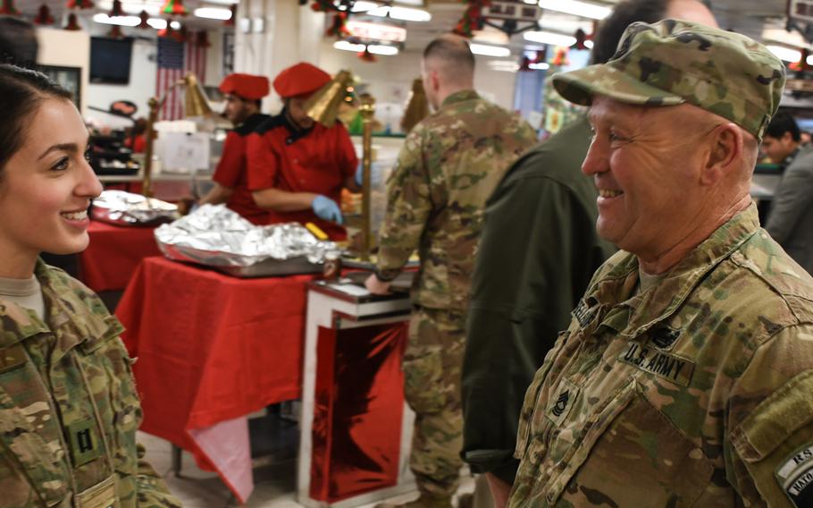 Capt. Vanessa Koodray, aide-de-camp to Maj. Gen. James B. Hecker, thanks Master Sgt. Davide Bellefleur, dining facility manager at Resolute Support headquarters in Kabul, Afghanistan, for the delicious food and the ''entire presentation'' of Christmas Day dinner on Monday, Dec. 25, 2017.
