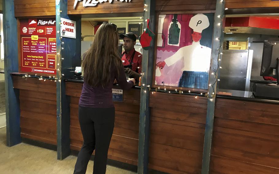 A customer orders lunch at the Pizza Hut in the exchange complex at Bagram Air Field on Wednesday, Dec. 20, 2017.
