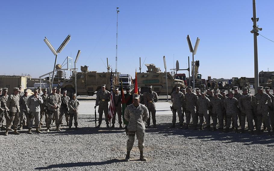 Marines from Task Force Southwest wait at parade rest for the start of a transfer of authority ceremony at Camp Shorab in Helmand province, Afghanistan, on Monday, Jan. 15, 2018. About 300 Marines from the task force's first rotation, represented by the platoon on the left, were relieved by a similarly-sized unit represented  by the platoon on the right.