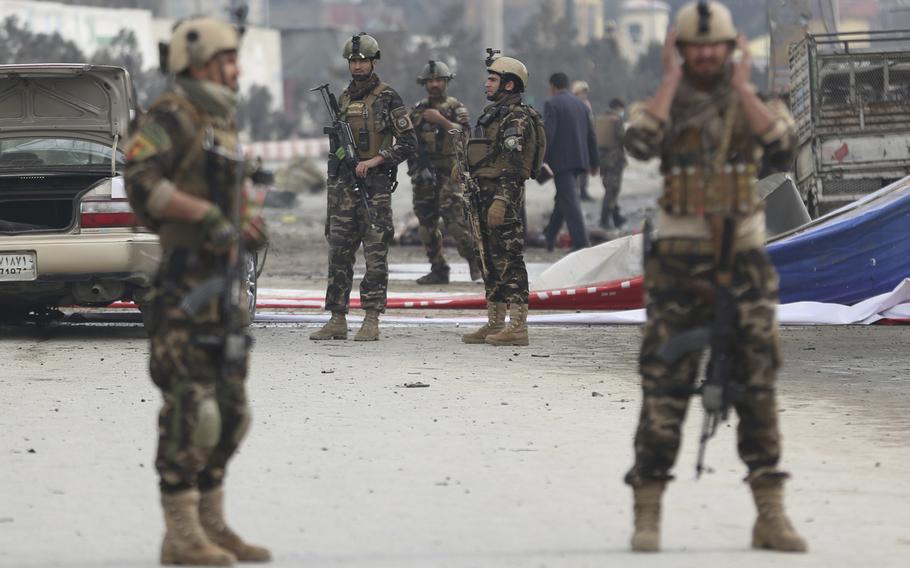 Security forces inspect the site of a suicide attack in Kabul, Afghanistan, Friday, March 2, 2018. A large explosion in the Afghan capital Friday killed at least one and wounded two dozen others, officials said.