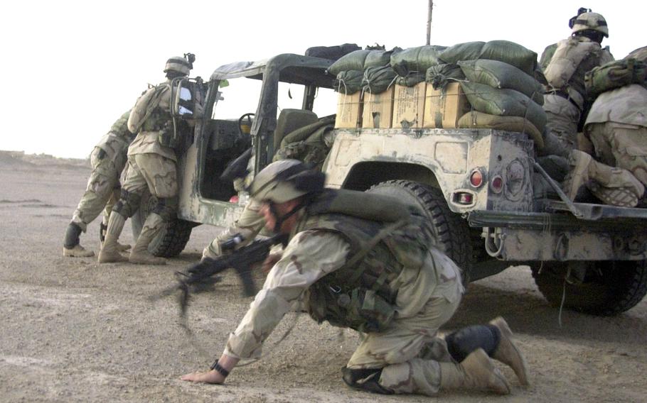 Soldiers near Fallujah scramble into position as rounds come in just minutes after Company B troops left Forward Operating Base Mercury in September 2003. The shooters melted into the night before soldiers could return fire or capture them.