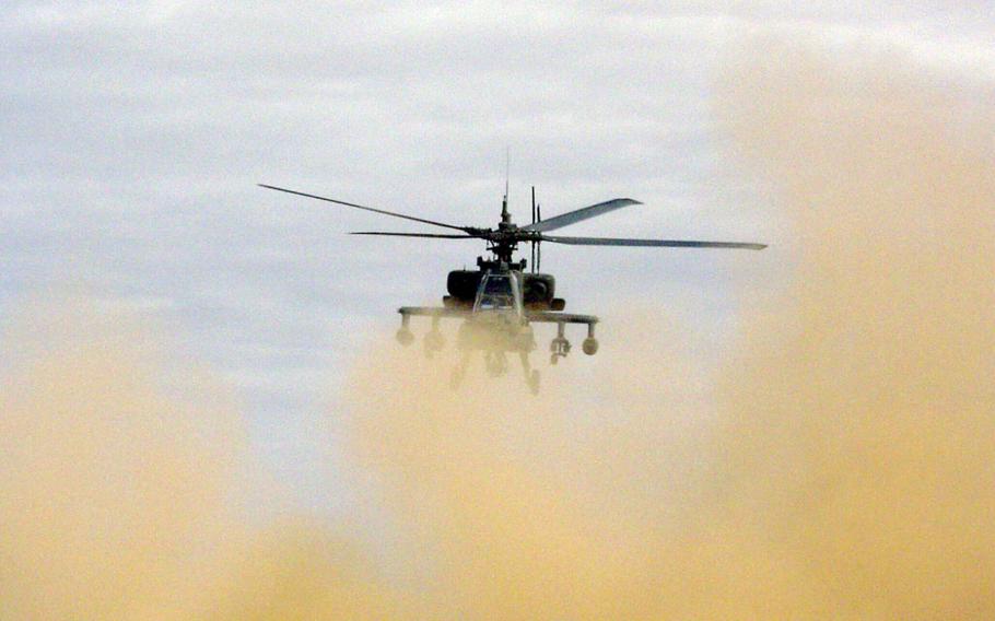 Chief Warrant Officer 3 Tim McCray and Chief Warrant Officer 2 Aaron Mitchell lift their AH-64A Apache off the ground en route to a mission against the former stronghold of the Iraqi Republican Guard's Medina Division, south of Baghdad in April 2003. The pilots are members of the 2nd Squadron, 6th Cavalry Regiment's Troop C. 