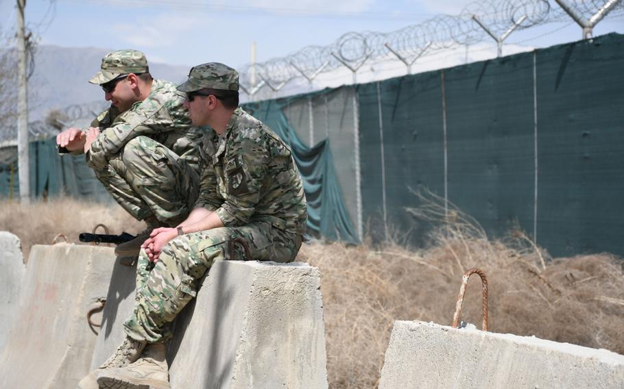 Georgian servicemembers watch their compatriots take on a team from Uganda during the Bagram World Cup soccer tournament at Bagram Air Filed, Afghanistan, on Friday, March 23, 2018. 