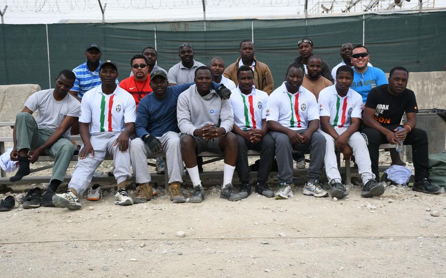 Don Baumgartner, right in blue, sits with players from Zimbabwe competing in the Bagram World Cup on Friday, March 23, 2018, in Afghanistan. 