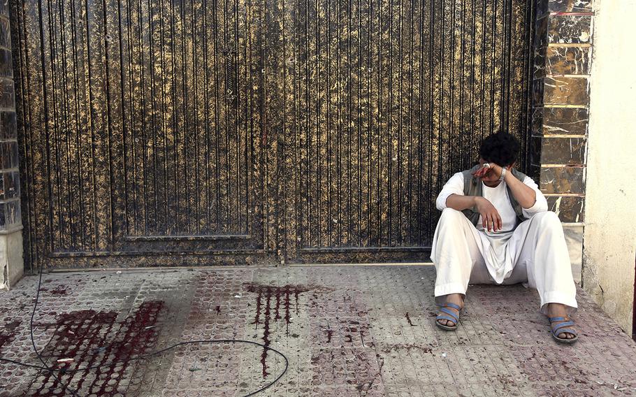 A relative of a victim cries outside a voter registration center which was attacked by a suicide bomber in Kabul, Afghanistan, Sunday, April 22, 2018.  Gen. Daud Amin, the Kabul police chief, said the suicide bomber targeted civilians who had gathered to receive national identification cards. 