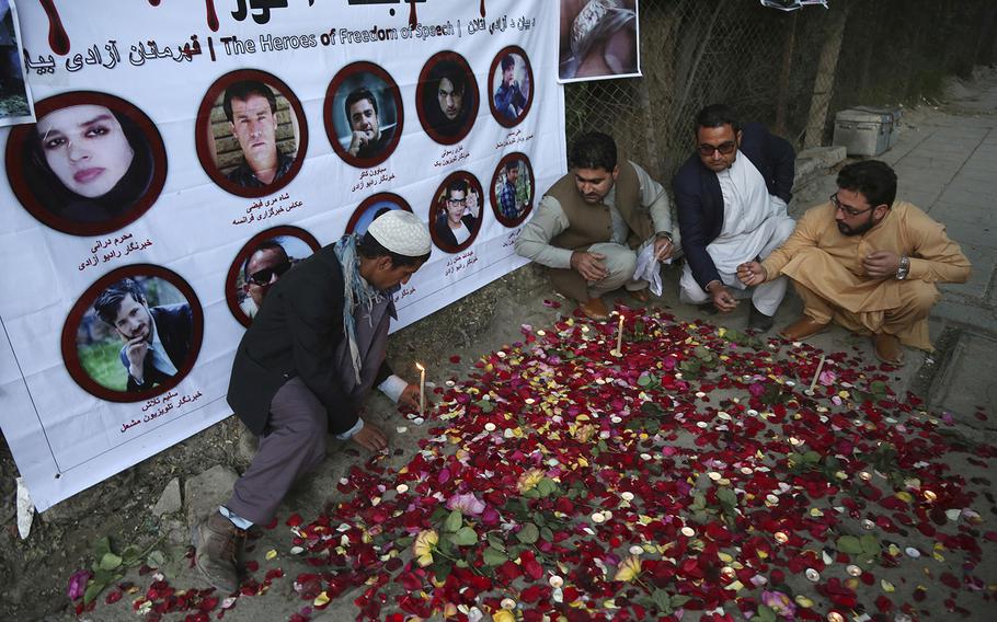 Afghan residents light candles Thursday, May 3, 2018, to pay tribute to Afghan journalists killed in Monday's suicide attack in Kabul, Afghanistan. Two Islamic State suicide bombers struck in Afghanistan's capital on Monday, April 30, 2018, killing 25 people, including nine journalists who had rushed to the scene of the first attack, in the deadliest assault on reporters since the fall of the Taliban in 2001.