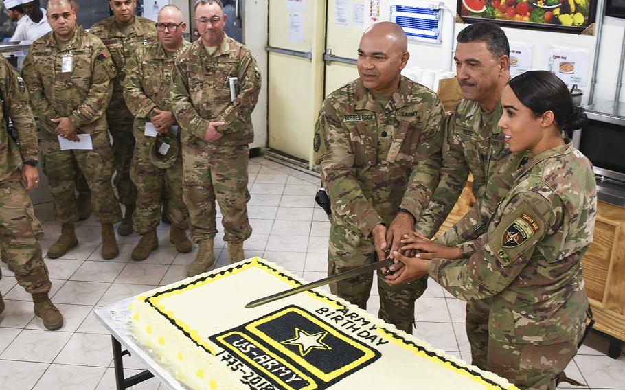 Soldiers of the 191st Regional Support Group Forward, deployed from Fort Allen, Puerto Rico, are pictured here preparing to cut an Army birthday cake during a ceremony at the NATO Resolute Support mission headquarters dining facility on Thursday, June 14, 2018, in Kabul, Afghanistan. Cake-cutters, from left, Lt. Col. Norberto Torres-Roca, Command Sgt. Maj. Andres Ruiz and Cpl. Ruby Cruz Quinones. Per tradition, Torres, 55, and Quinones, 24, were designated to cut the cake as the oldest and youngest soldiers present. 