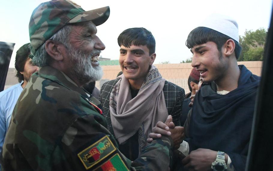 Brig. Gen. Abdul Raziq Safi, commander of the Afghan army's 4th Brigade, 203rd Corps, shakes hands with a suspected Taliban fighter on Friday, June 15, 2018, in Logar province's capital of Pul-e-Alam during the first day of a three-day Taliban cease-fire against the government.


