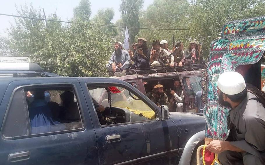 Taliban fighters ride atop a vehicle in an impromptu parade through Mihtarlam, the capital of Afghanistan's Laghman province, on Saturday, June 16, 2018, during a historic pair of unilateral cease-fires coinciding with the Eid al-Fitr holiday.
