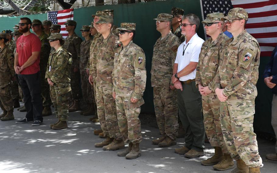 Troops and civilian contractors from U.S. and coalition countries attend an Independence Day ceremony at NATO's Resolute Support headquarters on Wednesday, July 4, 2018. 