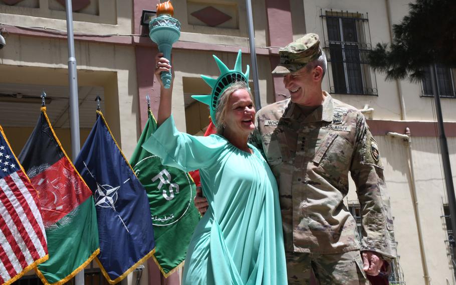 Stephenie Jonas-Sullivan, left, a U.S. citizen who advises the Afghan Interior Ministry on gender issues, celebrates Independence Day with Gen. John Nicholson, the U.S.'s top commander in Afghanistan, at NATO's Resolute Support headquarters on Wednesday, July 4, 2018. 