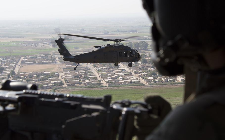 A U.S Army UH-60 Black Hawk door gunner watches as another Black Hawk flies over Syria on July 10, 2018. French Brig. Gen. Frederic Parisot, the director of civil-military operations of the U.S.-led Operation Inherent Resolve coalition, said at least two to three months of fighting remains to end the ISIS caliphate.