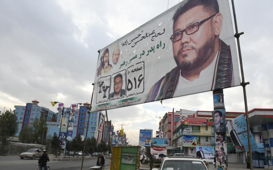 An election poster for a Hazara parliamentary candidate stands next to a main road in the Dasht-e-Barchi neighborhood of Kabul, Afghanistan, on Tuesday, Oct. 16, 2018. 

