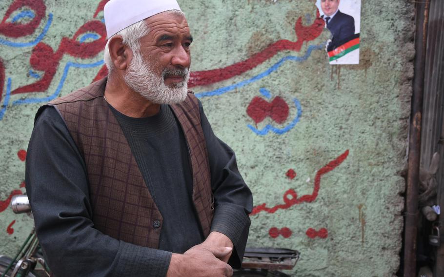 Dil Mohammad stands outside his shop in the Dasht-e-Barchi neighborhood of Kabul on Tuesday, Oct. 16, 2018, and explains how he will participate in upcoming parliamentary elections in the hope that it will make the area safer. 

