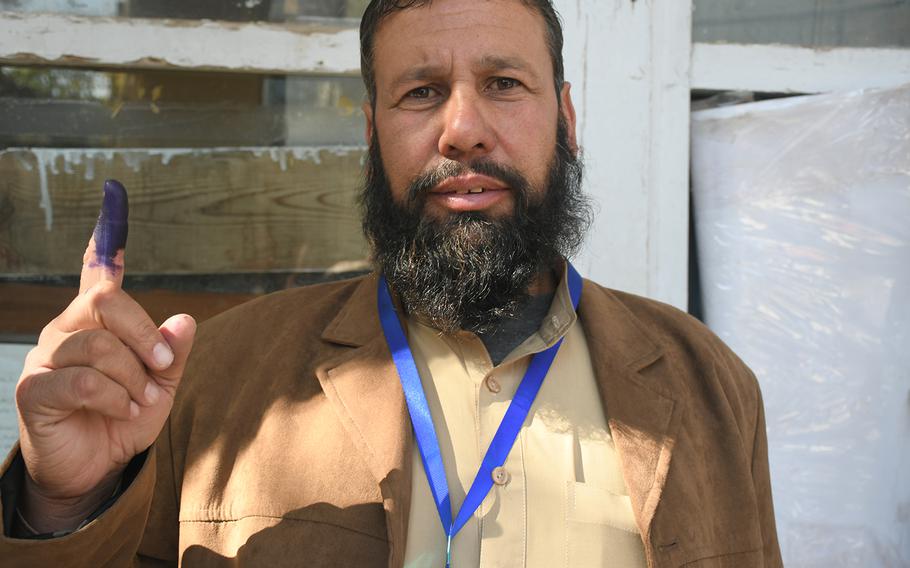 Kabul resident Mohammad Naiem shows ink on his finger on Saturday, Oct. 20, 2018, which indicates he voted in Afghanistan’s parliamentary elections. 