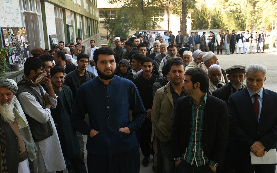 Men in Kabul line up to vote in Afghanistan's parliamentary elections on Saturday, Oct. 20, 2018. 