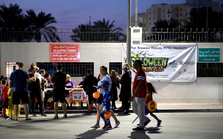 Volunteers check in families for the Bahrain School’s Spooktakular event on Thursday, Oct. 25, 2018. The two-day event saw as many as 1,000 participants led by 150 volunteers, including 25 sailors from nearby Naval Support Activity Bahrain.