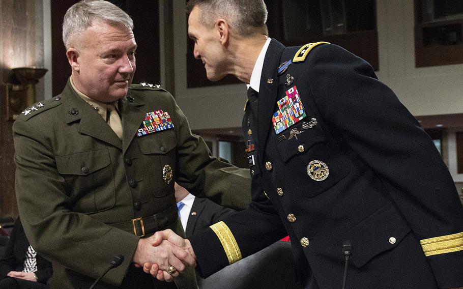 Lt. Gen. Kenneth F. McKenzie, Jr., left, nominee to serve as commander of U.S. Central Command, shakes hands with Lt. Gen. Richard D. Clarke, nominee to serve as commander of U.S. Special Operations Command, before their Senate Armed Services Committee confirmation hearing on Capitol Hill, Dec. 4, 2018.
