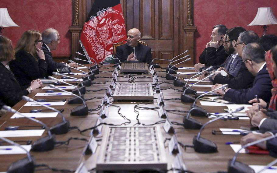 In this photo released by the Afghan Presidential Palace, Afghan President Ashraf Ghani, center, speaks to U.S. peace envoy Zalmay Khalilzad, third left, at the presidential palace in Kabul. Afghanistan, Monday, Jan. 28, 2019.