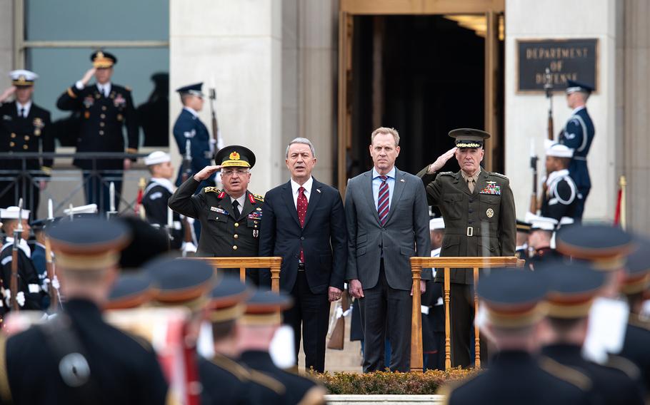 From left, Turkish Chief of General Staff Gen. Yasar Guler, Turkish Minister of National Defense Hulusi Akar, Acting U.S. Secretary of Defense Patrick Shanahan and Chairman of the Joint Chiefs of Staff, Gen. Joe Dunford stand during an arrival ceremony at the Pentagon's parade field in Washington on Friday, Feb. 22, 2019. 