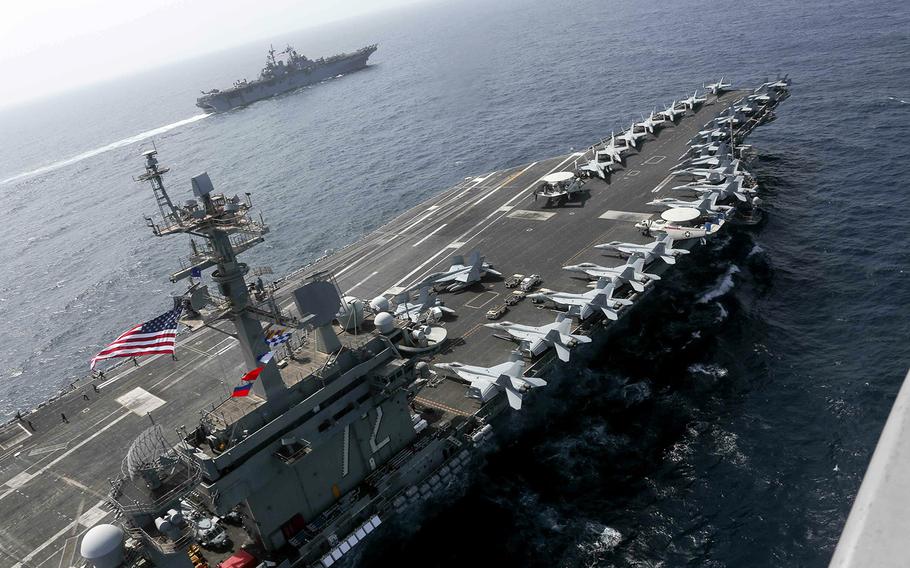 The USS Abraham Lincoln sails in the Arabian Sea near the amphibious assault ship USS Kearsarge on Friday, May 17, 2019. 