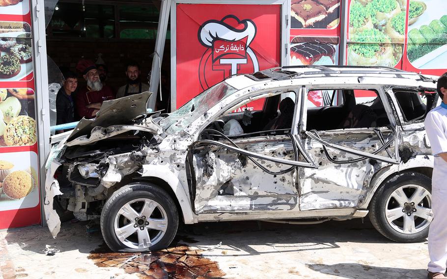 A burned out vehicle sits at the site of a suicide attack in Kabul, Afghanistan, Friday, May 31, 2019. A suicide car bomb exploded early Friday morning in an eastern neighborhood of the capital Kabul, leaving seven casualties, police said. 