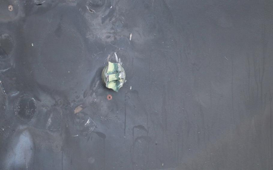 This is the view of the remnants of a removed limpet mine's placement, location, and damage sustained from a limpet mine attack, on the starboard side of motor vessel M/T Kokuka Courageous, while operating in the Gulf of Oman, June 13, 2019. A limpet mine is attached to a vessel via magnet and/or nails. The holes seen were created by nails used to hold the mine in place. 
