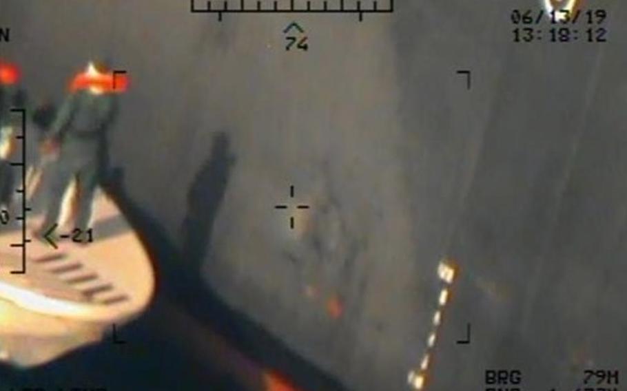 Imagery taken from a U.S. Navy MH-60R helicopter of the Islamic Revolutionary Guard Corps Navy after removing an unexploded limpet mine from the M/T Kokuka Courageous.