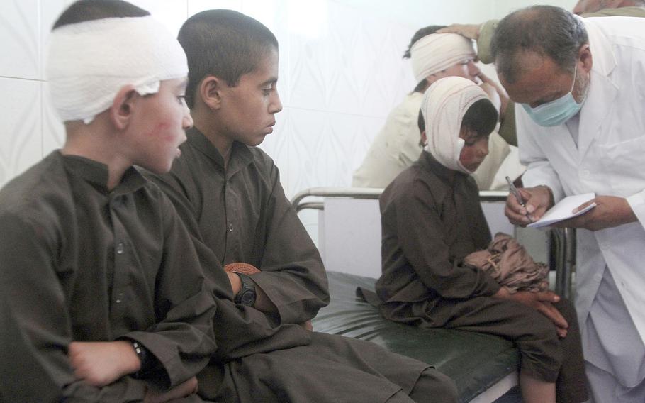 Injured boys receive treatment in a hospital after a car bomb attack in Ghazni province, central Afghanistan, Sunday, July 7, 2019. 
