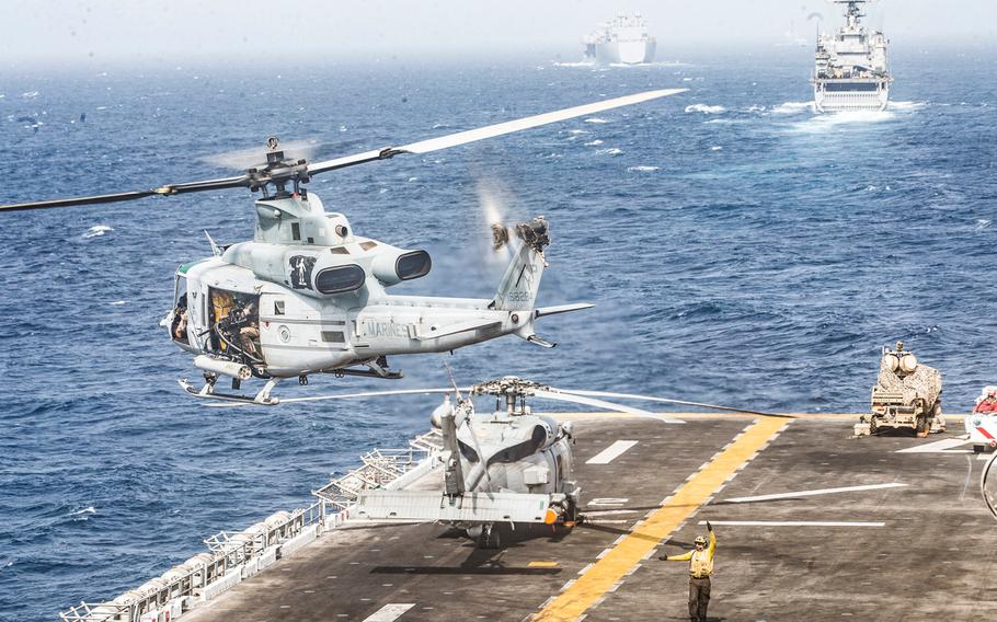 A UH-1Y Venom helicopter takes off from the flight deck of the amphibious assault ship USS Boxer (LHD 4) on July 18, 2019, while transiting through the Strait of Hormuz