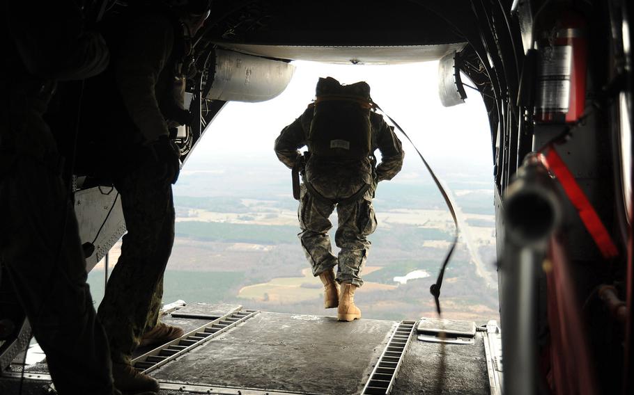U.S. Navy SEALs jump from a CH-46E Sea Knight helicopter during training near Fort Pickett on Dec. 20, 2011.