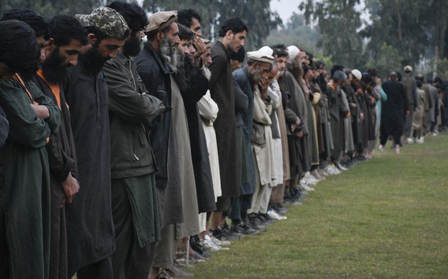 Islamic State fighters line up Nov. 19, 2019, in Jalalabad, Afghanistan, after surrendering to the Afghan government. An estimated 2,000 ISIS fighters and their family members are expected to surrender after government offensives, supported by U.S. and coalition forces, cut off their supply lines.